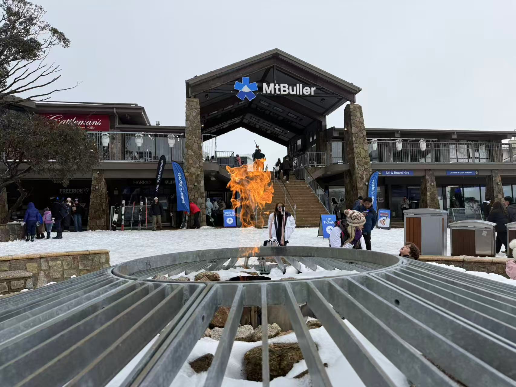 Mt Buller village entrance with fire pit on opening weekend 2026